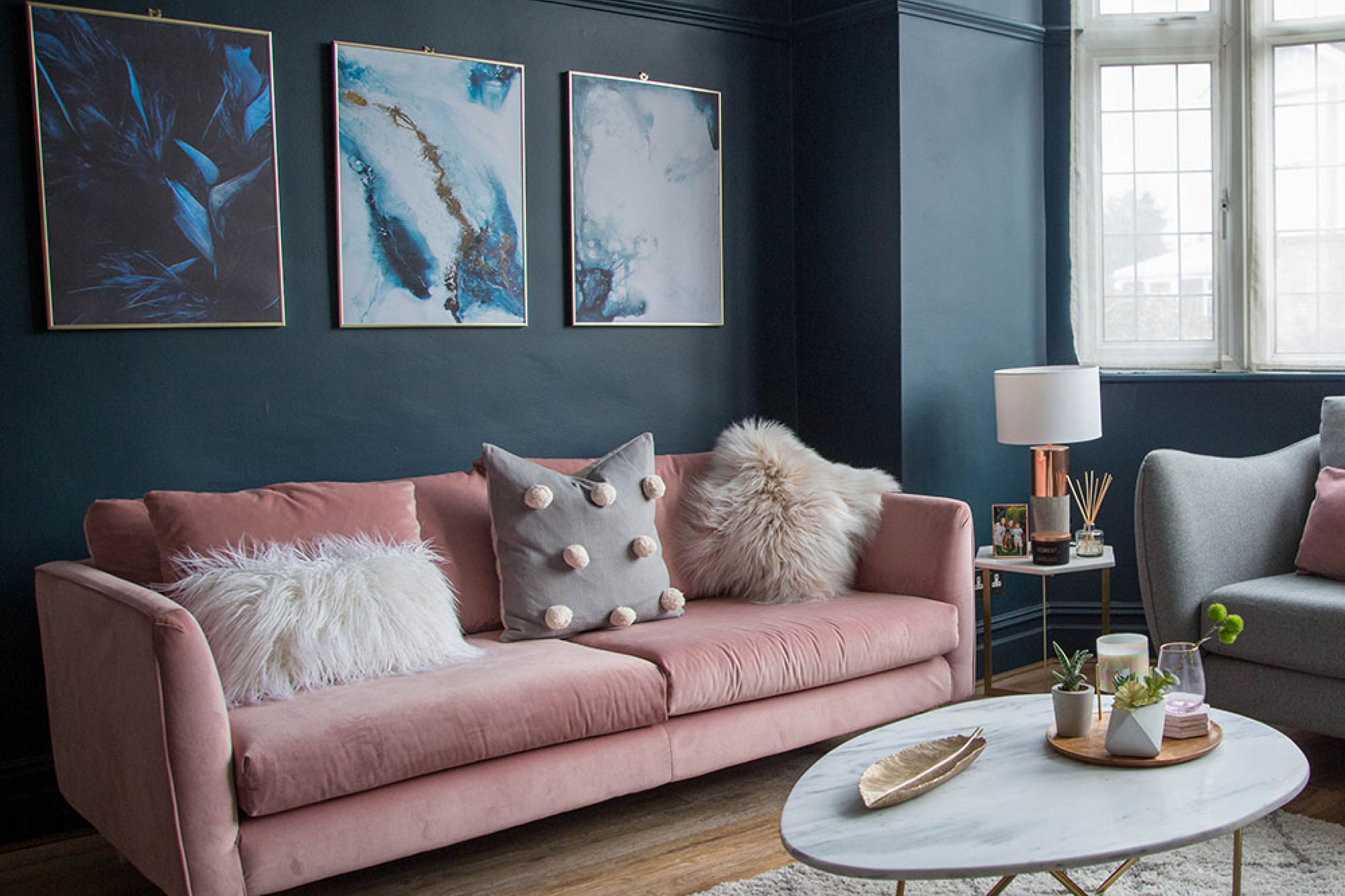 living-room-makeover-with-dark-blue-walls-pink-sofa-and-gold-accessories-2.jpg